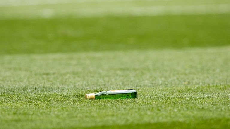 A glass bottle was thrown onto the pitch by a Rangers fan towards Celtic's Viljami Sinisalo