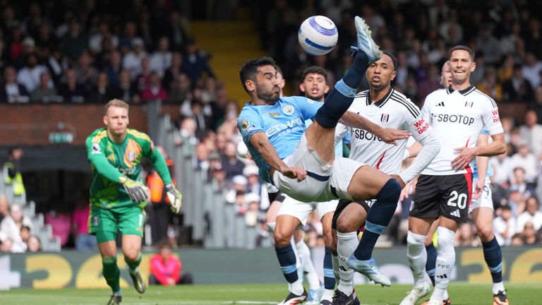 Manchester City's Ilkay Gundogan scores with an overhead kick to put them ahead at Fulham (AP Photo/Dave Shopland)