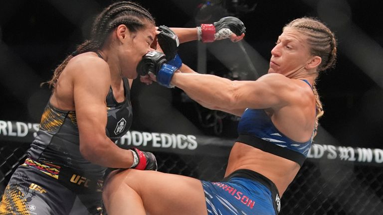 Kayla Harrison, right, punches Julianna Peña during the second round of the women's bantamweight title bout at UFC 316 