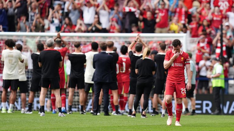 Andy Robertson was visibly emotional as Liverpool players applauded the travelling away fans, who were signing Diogo Jota's name