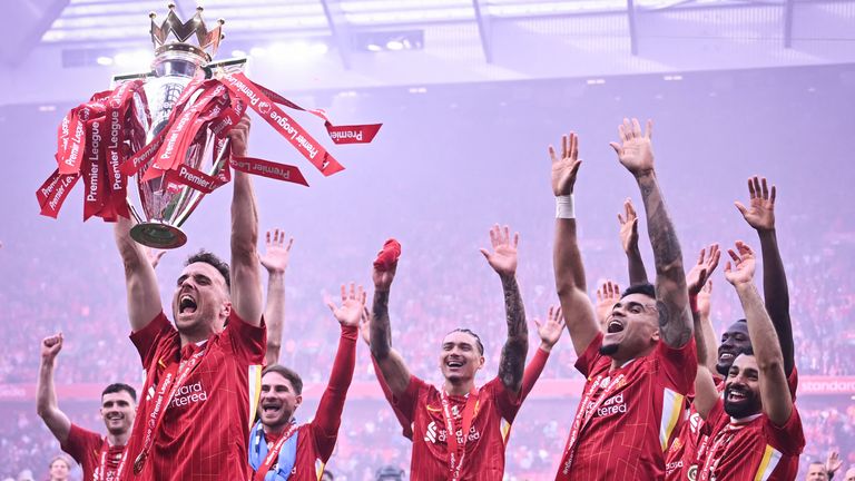 Diogo Jota lifts the Premier League trophy amid Liverpool's celebrations at the end of the 2024/25 season