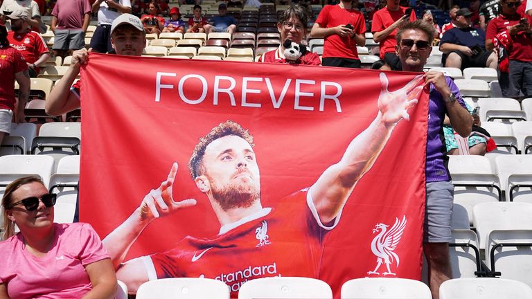 Liverpool fans hold up a flag paying tribute to Diogo Jota ahead of the game against Preston North End