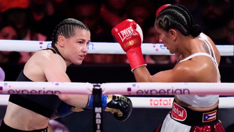 Ireland's Katie Taylor, left, punches Puerto Rico's Amanda Serrano during the first round of a super lightweight championship boxing match Friday, July 11, 2025, in New York. (AP Photo/Frank Franklin II)