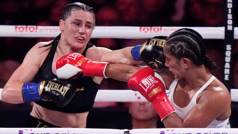 Ireland's Katie Taylor, left, punches Puerto Rico's Amanda Serrano during the ninth round of a super lightweight championship boxing match Saturday, July 12, 2025, in New York. (AP Photo/Frank Franklin II)