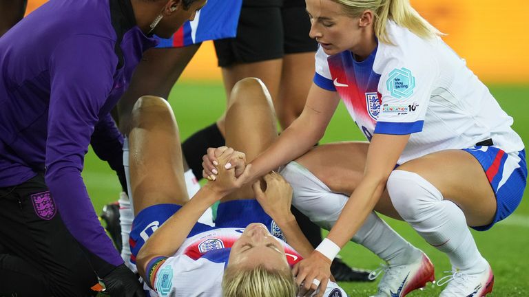 England's Chloe Kelly holds the hand of teammate Leah Williamson after she got injured 
