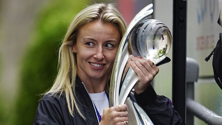 Leah Williamson with the Women's Euros trophy as England left their team hotel in Zurich