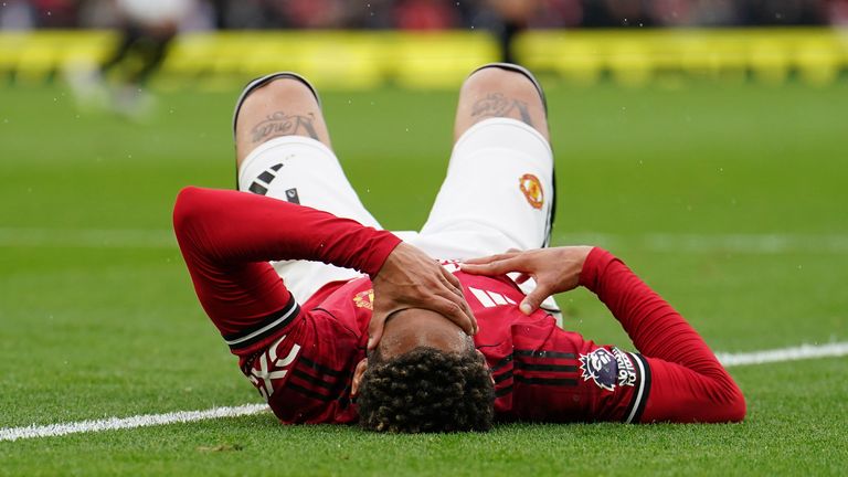 Manchester United's Matheus Cunha reacts after pulling up with an injury