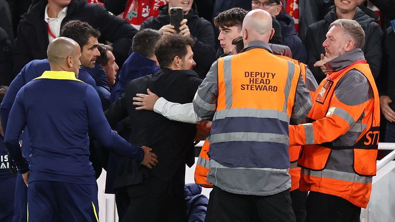 Diego Simeone clashes with a Liverpool fan towards the end of the match