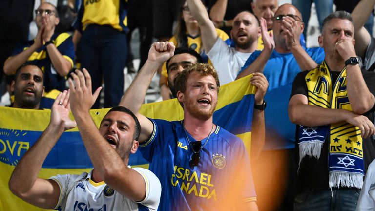 Maccabi Tel Aviv fans cheer on their side against PAOK in the Europa League