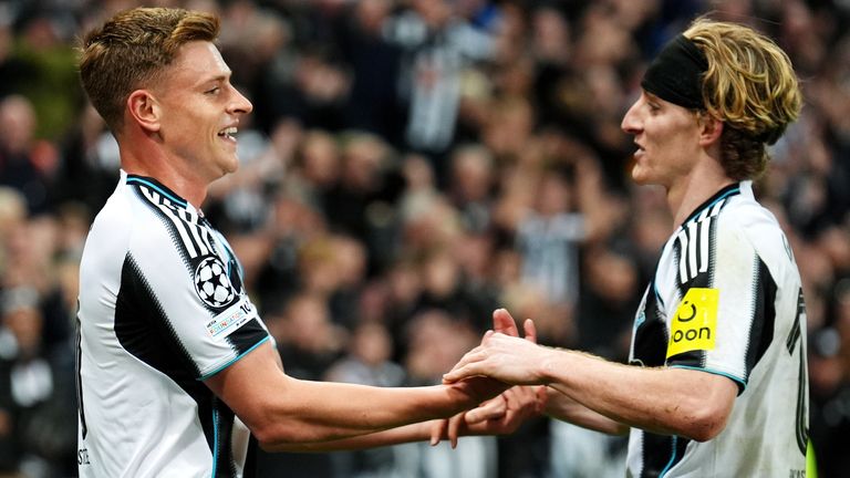 Newcastle United's Harvey Barnes (left) celebrates with Anthony Gordon after scoring their third goal against Benfica