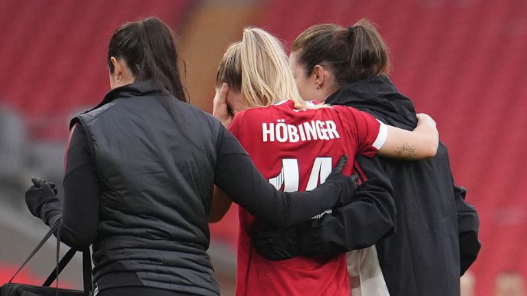 Marie Hobinger is helped off the pitch by Liverpool medical staff after picking up an injury