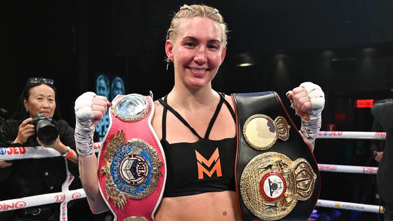 Mikaela Mayer poses with the WBA, WBO and WBC belts following her Super Welterweight Championship fight against Mary Spencer in Montreal, Thursday, Oct. 30, 2025. (Graham Hughes/The Canadian Press via AP)