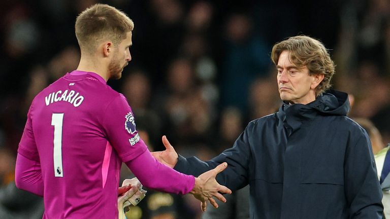 Tottenham head coach Thomas Frank shakes hands with goalkeeper Guglielmo Vicario after the defeat to Fulham