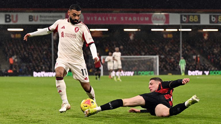 Adrien Truffert makes a sliding challenge on Mohamed Salah