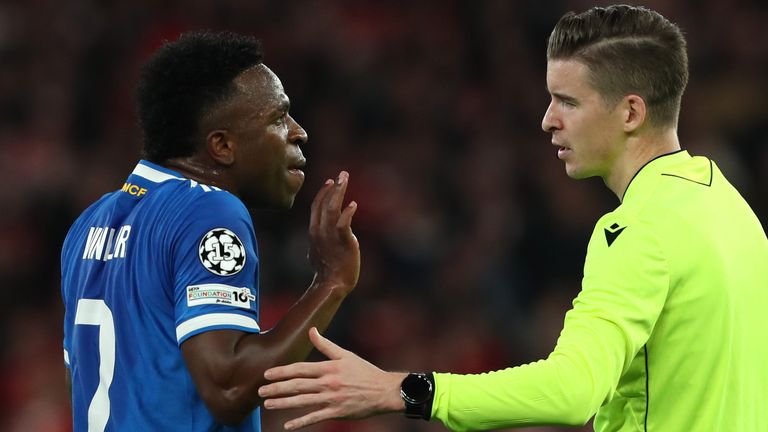 Vinicius Jr speaks to referee Francois Letexier after Benfica's Gianluca Prestianni appeared to make a comment towards him