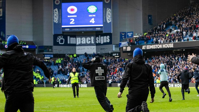 Fans storm the pitch at full time during the Scottish Cup Quarter-Final match between Rangers and Celtic