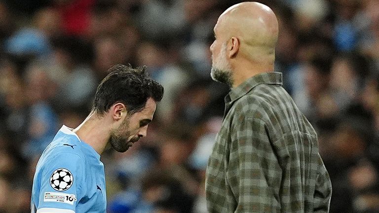 Pep Guardiola looks on as Bernardo Silva leaves the field after being sent off for handball