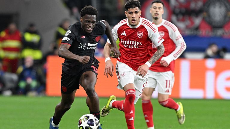 Bayer Leverkusen's Ernest Poku and Piero Hincapie battle for the ball