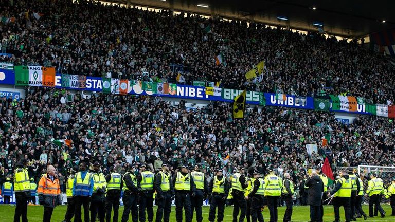 Police had to keep Rangers and Celtic fans apart after they ran onto the pitch at Ibrox