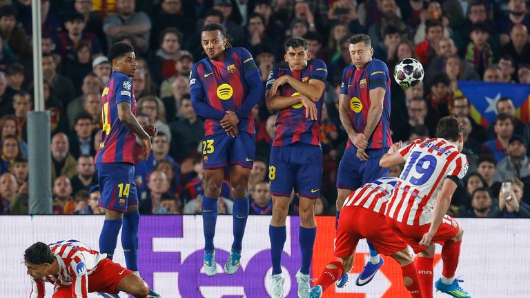 Atletico Madrid's Julian Alvarez, right, takes a free kick during the Champions League quarterfinal first leg soccer match between Barcelona and Atletico Madrid in Barcelona, Spain, Wednesday, April 8, 2026. (AP Photo/Joan Monfort)