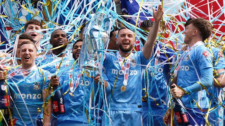 Coventry captain Matt Grimes and team-mates celebrate with the Championship trophy