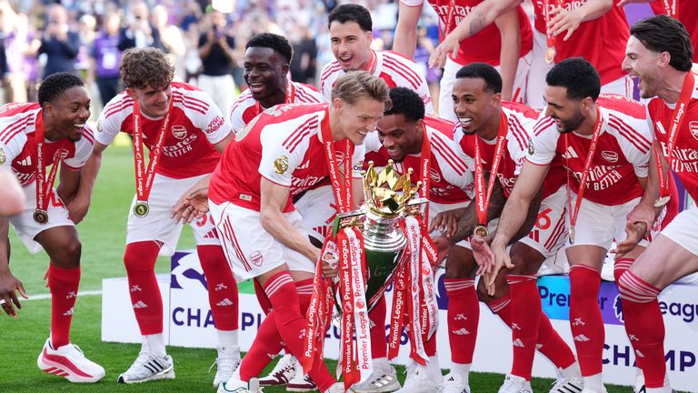 Arsenal's Martin Odegaard lifts the Premier League trophy