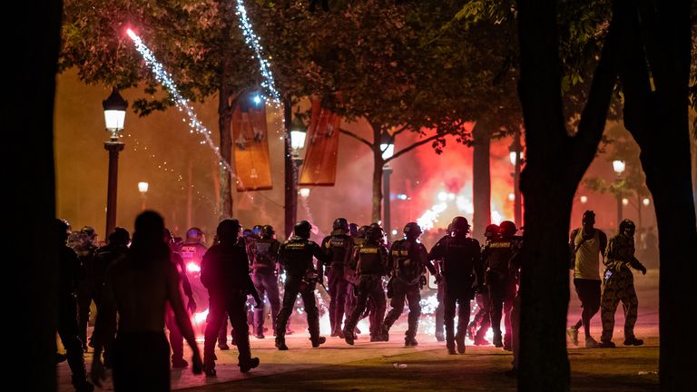 Clashes occur between PSG supporters and police along the Champs-Elysees during celebrations following PSG's Champions League win