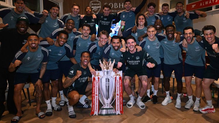 Arsenal players celebrate winning the Premier League after watching Bournemouth v Man City at their London Colney training centre