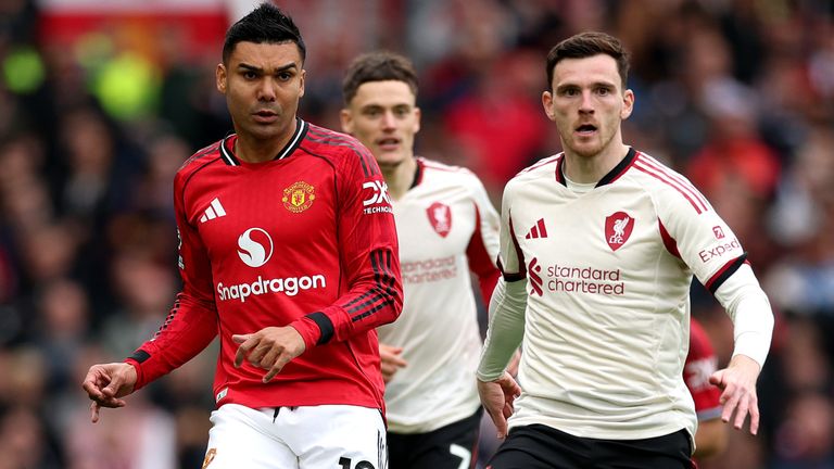 Casemiro makes a pass under pressure from Andy Robertson