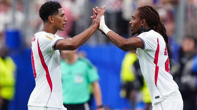 Djed Spence and Jude Bellingham high five each other during a substition in England's 2026 World Cup match against Croatia