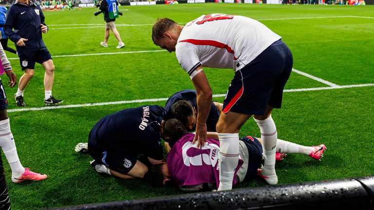 Jordan Henderson receives treatment after suffering an injury in the post-game celebrations following England's win against Mexico