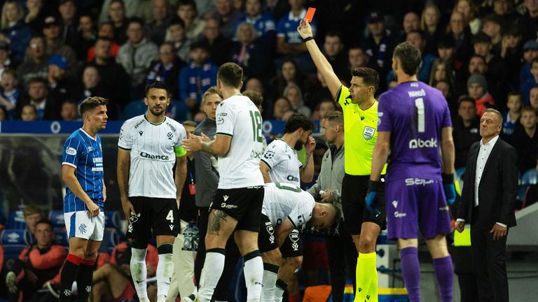 GLASGOW, SCOTLAND - AUGUST 20: Referee Marian Barbu shows a red card to Rangers Cammy Devlin during a UEFA Conference League Playoff Round First Leg match between Rangers and Jablonec, at Ibrox Stadium, on August 20, 2026, in Glasgow, Scotland. (Photo by Craig Foy / SNS Group)