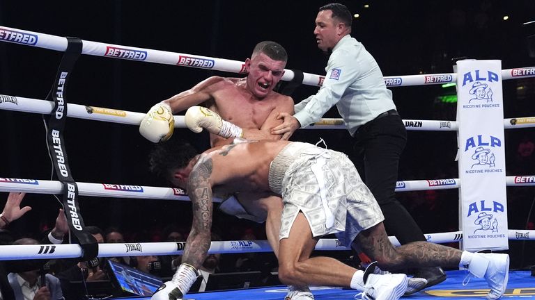 Whittaker slumps into Wallace on the ropes